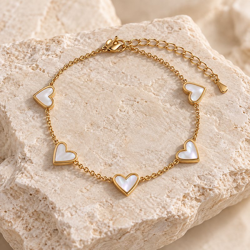 gold heart charm bracelet on stone