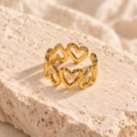 gold heart link ring on travertine
