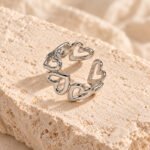 silver heart linked ring on travertine
